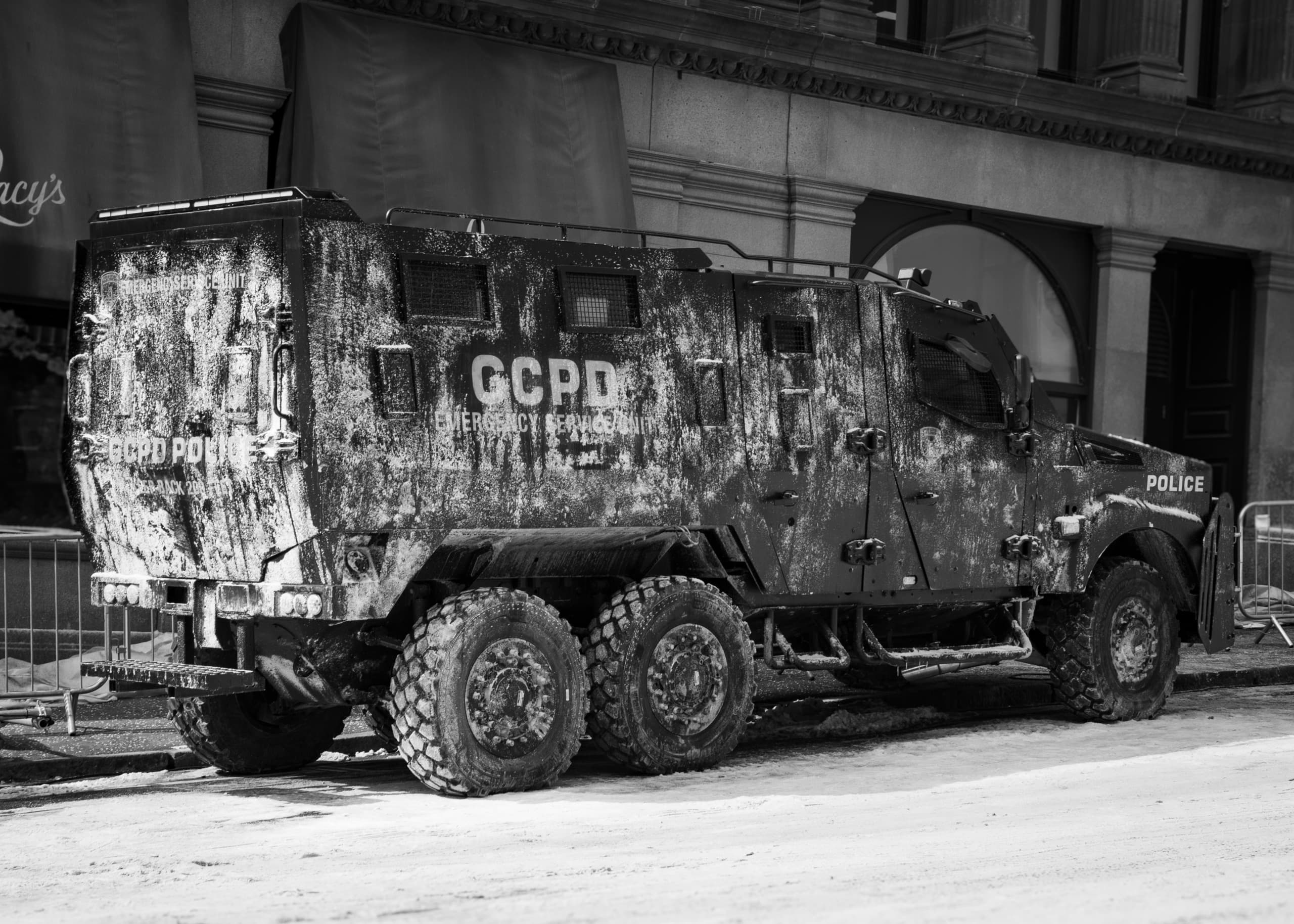 An armored police vehicle with the text GCPD on the side. It is covered in a material to make it look like it's covered in rock salt.