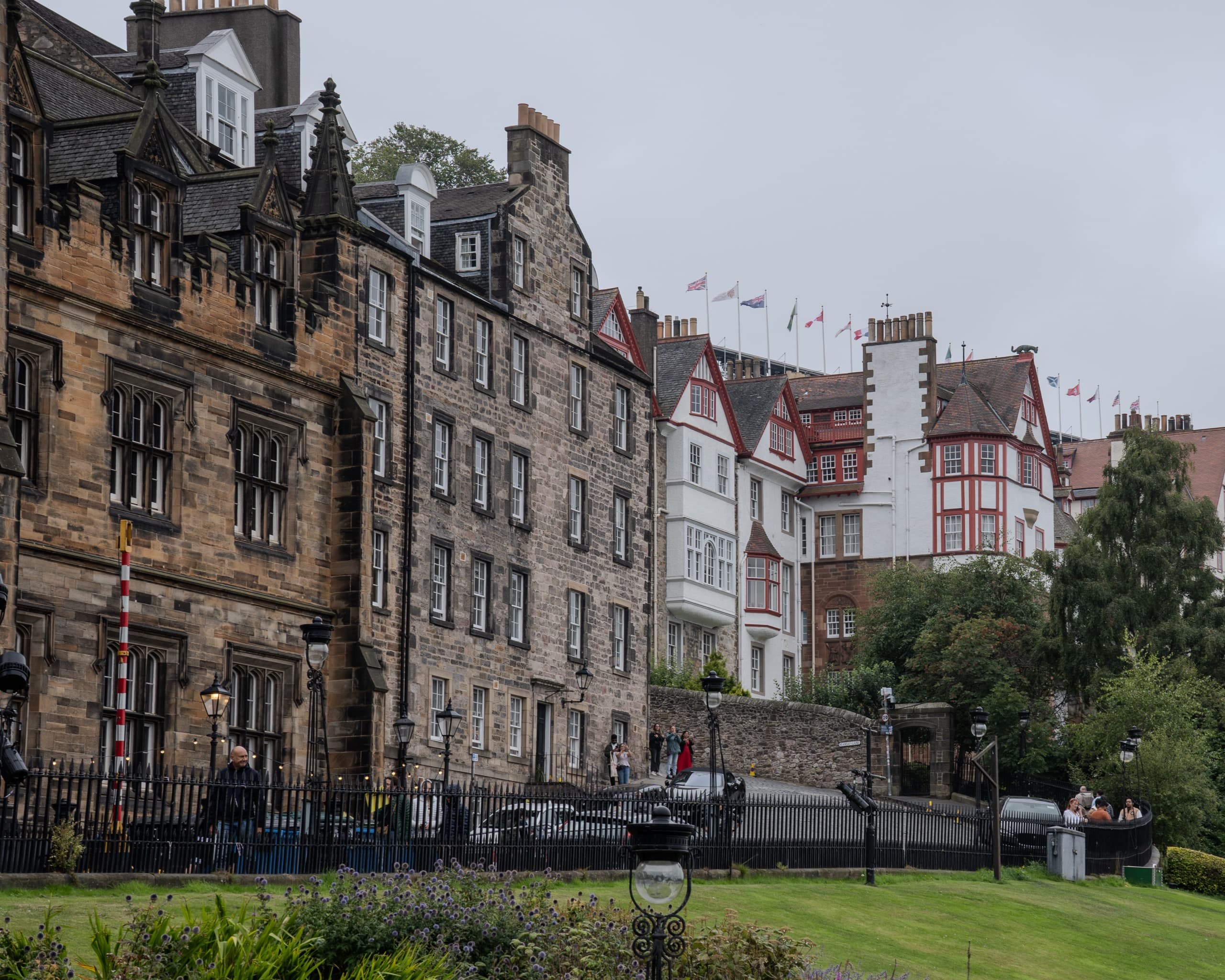 A row of older stone buildings packed together on the side of a street.